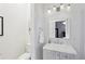 Clean bathroom featuring a gray vanity, modern fixtures, and a well-lit mirror at 313 5Th Ne St, Atlanta, GA 30308