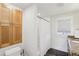 Bathroom featuring a granite countertop vanity, shower and bath with shower curtain at 313 5Th Ne St, Atlanta, GA 30308