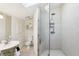 Bathroom featuring a glass shower, toilet, and vanity, accented by a skylight and tiled walls at 313 5Th Ne St, Atlanta, GA 30308