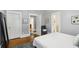 Bedroom featuring white trim, doorways, hardwood floors and a cozy rug at 313 5Th Ne St, Atlanta, GA 30308