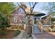 Charming home exterior featuring a spacious wooden deck with stairs and a well-maintained landscaped yard at 313 5Th Ne St, Atlanta, GA 30308
