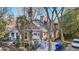 Charming brown two-story home with a covered front porch, classic columns, and a well-maintained landscaped yard at 313 5Th Ne St, Atlanta, GA 30308