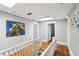 Second-floor hallway with hardwood floors, skylights, and white trim at 313 5Th Ne St, Atlanta, GA 30308