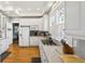 Kitchen featuring white cabinets, stainless appliances, gas cooktop, and hardwood floors at 313 5Th Ne St, Atlanta, GA 30308