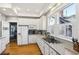 Well-lit kitchen featuring bright cabinets and countertops, modern appliances, and hardwood flooring throughout at 313 5Th Ne St, Atlanta, GA 30308