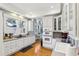 Updated kitchen features white cabinetry, stainless appliances, and hardwood floors at 313 5Th Ne St, Atlanta, GA 30308