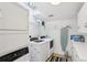 Functional laundry room with modern washer, dryer, ample storage, and a skylight for natural lighting at 313 5Th Ne St, Atlanta, GA 30308