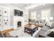 Bright living room with a fireplace, built-in shelving, and large windows at 313 5Th Ne St, Atlanta, GA 30308