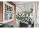 Covered front porch with comfortable seating, ceiling fans and decorative accents at 313 5Th Ne St, Atlanta, GA 30308
