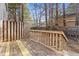 Wooden back deck with railings overlooking a fenced backyard filled with trees and natural surroundings at 5940 Hampton Ct, Atlanta, GA 30349