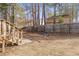 A fenced backyard with grass and wooded area for privacy and outdoor enjoyment at 5940 Hampton Ct, Atlanta, GA 30349