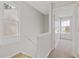 Bright upstairs hallway with carpeted stairs, trim, and plenty of natural light at 5940 Hampton Ct, Atlanta, GA 30349