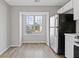 Well-lit kitchen featuring a large window with stainless steel refrigerator at 5940 Hampton Ct, Atlanta, GA 30349