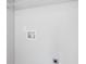 This laundry area includes washer-dryer hookups and convenient overhead shelving for organizing laundry essentials at 5940 Hampton Ct, Atlanta, GA 30349