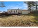 View of backyard featuring a wood deck, siding, and a small garage at 9515 Deerfield Ln, Jonesboro, GA 30238