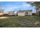 A house backyard featuring a wooden deck, well-maintained lawn, and vinyl siding at 9515 Deerfield Ln, Jonesboro, GA 30238