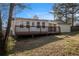 The backyard boasts a wood deck, a garage, and mature trees at 9515 Deerfield Ln, Jonesboro, GA 30238