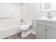 Bright bathroom features a shower-tub combo and single sink vanity at 9515 Deerfield Ln, Jonesboro, GA 30238