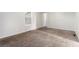 Bright bedroom with neutral walls, plush carpet, and a window at 9515 Deerfield Ln, Jonesboro, GA 30238