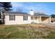 Inviting single-story home with light yellow siding, dark shutters, and a well-kept lawn at 9515 Deerfield Ln, Jonesboro, GA 30238