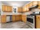 Functional kitchen with wood cabinets, stainless steel appliances, modern flooring, and natural light at 9515 Deerfield Ln, Jonesboro, GA 30238