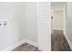 Functional laundry area features bi-fold doors and wood-look vinyl flooring at 9515 Deerfield Ln, Jonesboro, GA 30238