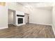 Bright living room featuring a cozy fireplace, modern flooring, vaulted ceilings and plenty of natural light at 9515 Deerfield Ln, Jonesboro, GA 30238