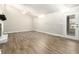 Open living room featuring hardwood floors, high ceilings, and a door to the outside at 9515 Deerfield Ln, Jonesboro, GA 30238