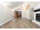 Spacious living area with hardwood floors, a fireplace, tall ceilings, and seamless access to the kitchen at 9515 Deerfield Ln, Jonesboro, GA 30238