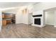 Inviting living room with a brick fireplace, hardwood floors, high ceilings, and an open layout to the kitchen at 9515 Deerfield Ln, Jonesboro, GA 30238