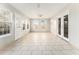 Bright sunroom with large windows, tile flooring, and entry/exit doors on multiple sides at 9515 Deerfield Ln, Jonesboro, GA 30238