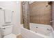 Bright bathroom features a tiled shower-over-tub with curtain and a modern toilet at 1000 Beckwith Sw St, Atlanta, GA 30314