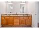 Bathroom featuring wood cabinets, double sinks and granite countertop at 1000 Beckwith Sw St, Atlanta, GA 30314