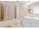 Charming bathroom featuring a shower-over-tub, white cabinet vanity and tiled floors at 1000 Beckwith Sw St, Atlanta, GA 30314