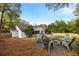 Charming backyard featuring a fire pit, seating, lush greenery, and a well-maintained lawn at 2327 Ewing Ne Dr, Brookhaven, GA 30319