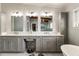 Elegant bathroom with double vanity, white countertops, gray cabinets, and stool at a seated makeup area at 2327 Ewing Ne Dr, Brookhaven, GA 30319