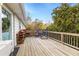 Spacious wood deck featuring outdoor seating, a grill, and mature trees at 2327 Ewing Ne Dr, Brookhaven, GA 30319