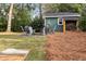 Cozy backyard firepit area with chairs, firewood storage, and lush green lawn at 2327 Ewing Ne Dr, Brookhaven, GA 30319