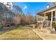 Expansive backyard with a stone patio, a built-in fire pit, and mature trees at 4005 Princeton Trce, Cumming, GA 30041