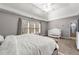 Well-lit bedroom featuring a ceiling fan, ensuite bath and window view at 4005 Princeton Trce, Cumming, GA 30041