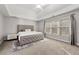 Bright bedroom featuring large window, ceiling fan, carpet and a queen bed at 4005 Princeton Trce, Cumming, GA 30041