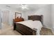 Cozy bedroom featuring a queen bed, ceiling fan and dresser with a mirror at 4005 Princeton Trce, Cumming, GA 30041