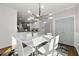 Dining room with stylish chandelier, modern table, and view into the eat-in kitchen at 4005 Princeton Trce, Cumming, GA 30041