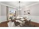 Elegant dining room with a modern chandelier and a view of the home's exterior at 4005 Princeton Trce, Cumming, GA 30041