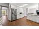 Bright kitchen with stainless steel appliances, white cabinetry, and hardwood floors at 4005 Princeton Trce, Cumming, GA 30041