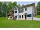 Back exterior elevation of a two-story home overlooking a spacious, landscaped yard at 836 Bailey Woods Rd, Dacula, GA 30019