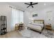 Cozy bedroom features wood floors, a ceiling fan, and natural light at 836 Bailey Woods Rd, Dacula, GA 30019