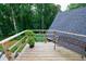 Wooden deck with a view of the trees with a bench at 836 Bailey Woods Rd, Dacula, GA 30019