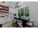 Cozy dining area with a large window, modern lighting, and stylish white cabinets at 836 Bailey Woods Rd, Dacula, GA 30019