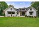 Stunning white brick home with a lush green lawn and meticulously landscaped flower beds at 836 Bailey Woods Rd, Dacula, GA 30019